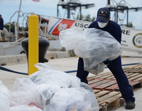 A_crew_member_aboard_the_Coast_Guard_Cutter_Legare_offloads_seized_cocaine_at_Coast_Guard_Base_Miami_Beach,_Florida