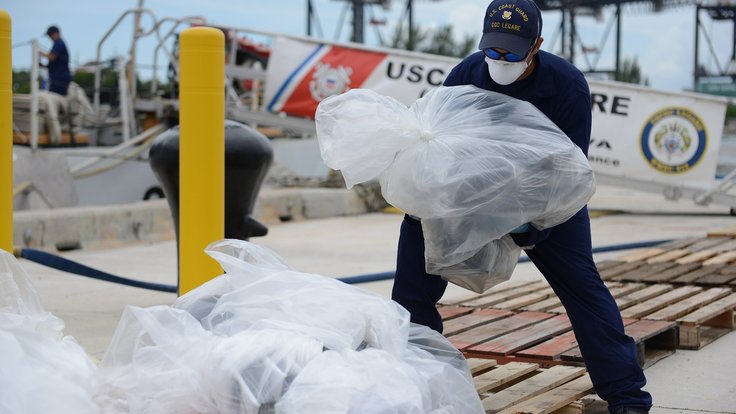 A_crew_member_aboard_the_Coast_Guard_Cutter_Legare_offloads_seized_cocaine_at_Coast_Guard_Base_Miami_Beach,_Florida