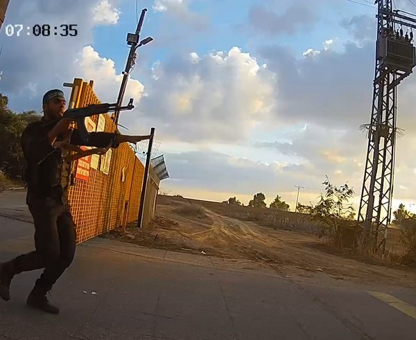Armed_Hamas_gunmen_storming_the_gate_of_Kibbutz_Alumim_October_7_2023