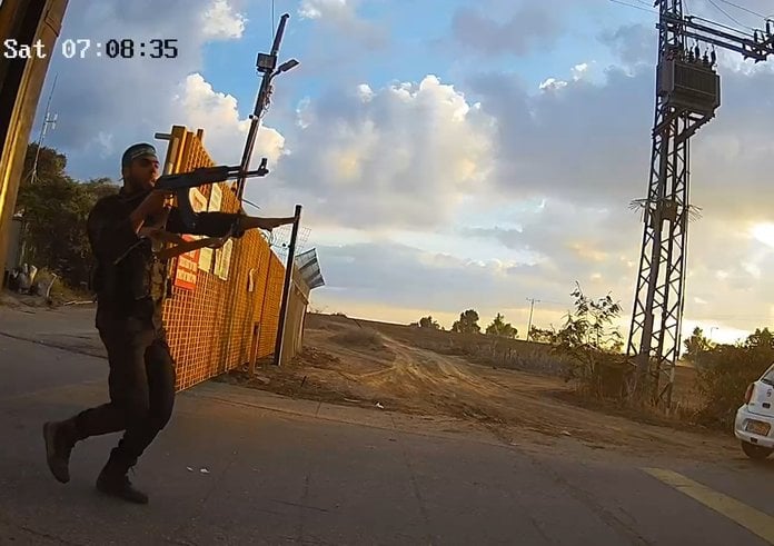 Armed_Hamas_gunmen_storming_the_gate_of_Kibbutz_Alumim_October_7_2023