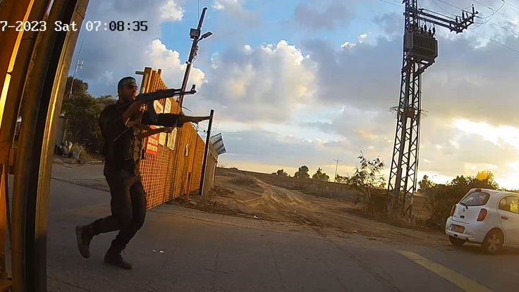 Armed_Hamas_gunmen_storming_the_gate_of_Kibbutz_Alumim_October_7_2023