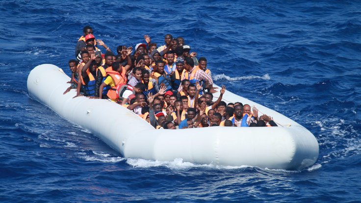 Inflatable_boat_carrying_migrants_approaching_USS_Carney_(DDG-64)_in_the_Mediterranean_160729-N-EU999-004