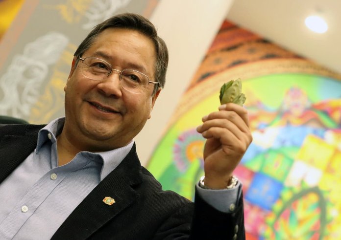 Luis_Arce_holds_up_a_Coca_Leaf._29_June_2022,_Vice_Ministry_of_Communication,_La_Paz._(52183345624)
