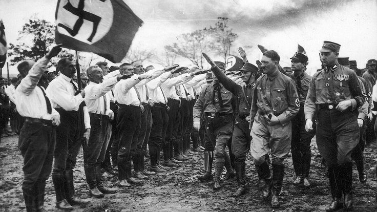 NSDAP_branch_in_Oldenburg_saluting_Hitler_(Nov_1930__Swiatowid_29_1931-07-18)_R_Hess,_V_Lutze,_Carl_Röver_(behind_arm)_Nazi_propaganda_swastika_flag_Party_veterans_in_Verbotsuniform__Narodowe_Archiwum_Cyfrowe_3_1_0