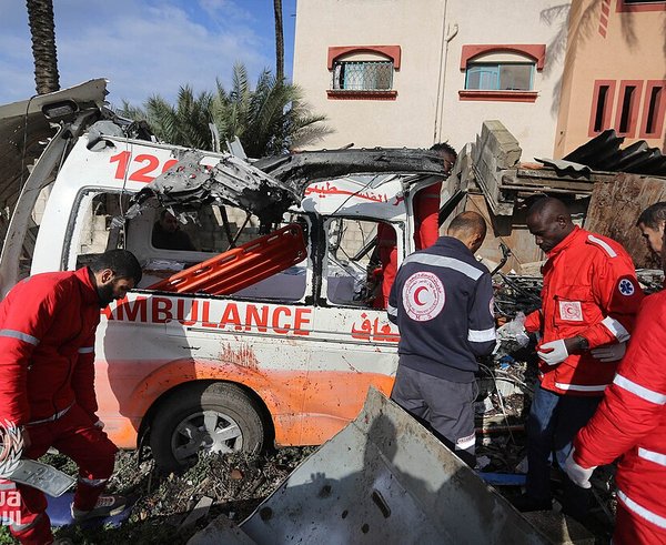 Palestinian_Red_Crescent_Personnel_inspect_a_destroyed_ambulance_in_Deir_el-Balah_,_Gaza_Strip