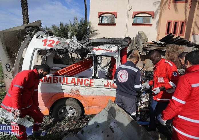 Palestinian_Red_Crescent_Personnel_inspect_a_destroyed_ambulance_in_Deir_el-Balah_,_Gaza_Strip