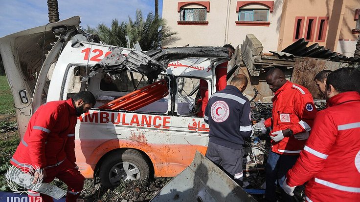 Palestinian_Red_Crescent_Personnel_inspect_a_destroyed_ambulance_in_Deir_el-Balah_,_Gaza_Strip