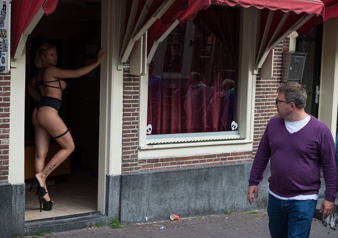 Prostitute_in_doorway,_Amsterdam