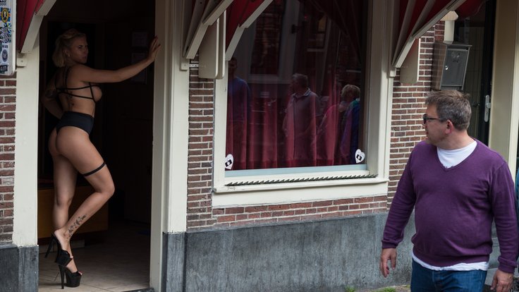 Prostitute_in_doorway,_Amsterdam