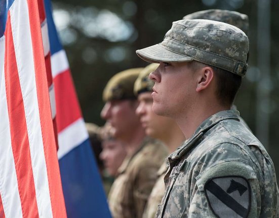 a-us-army-soldier-stands-ready-to-raise-the-american-3b48a2