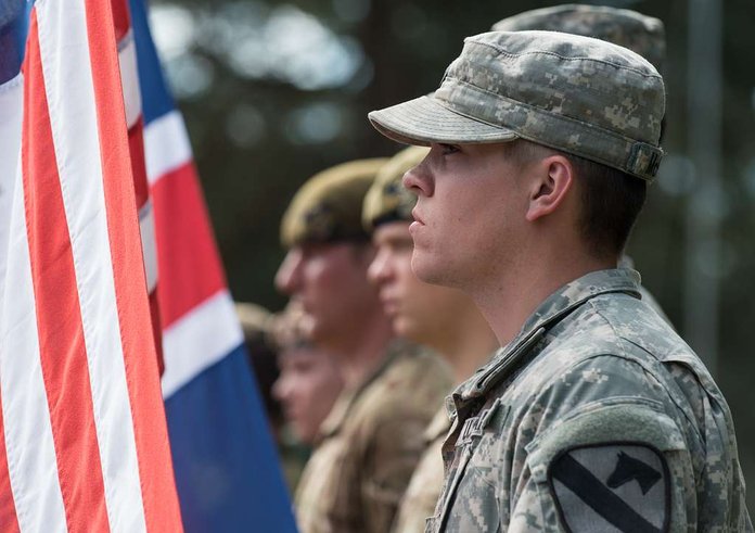 a-us-army-soldier-stands-ready-to-raise-the-american-3b48a2