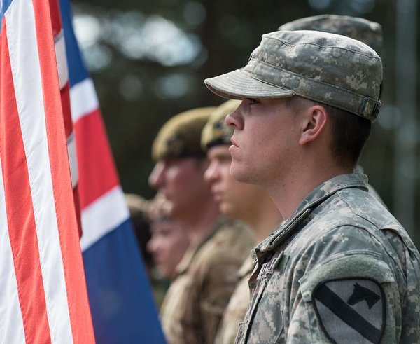 a-us-army-soldier-stands-ready-to-raise-the-american-3b48a2