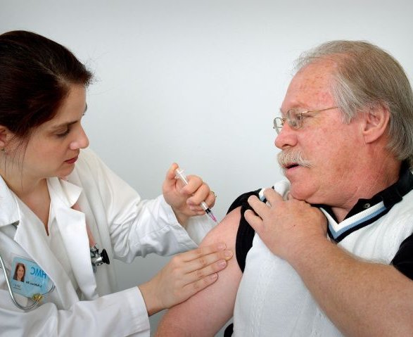middle-aged-man-receiving-an-intramuscular-immunization-into-his-left-shoulder-muscle-from-a-female-nurse-725x479