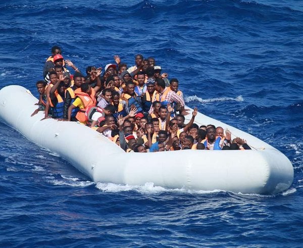 migrants-aboard-an-inflatable-vessel-approach-the-guided-missile-destroyer-fec78f-1024