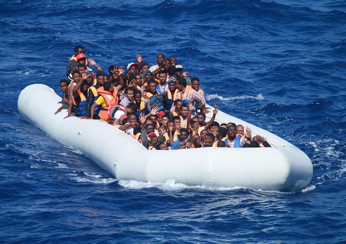 migrants-aboard-an-inflatable-vessel-approach-the-guided-missile-destroyer-fec78f-1024