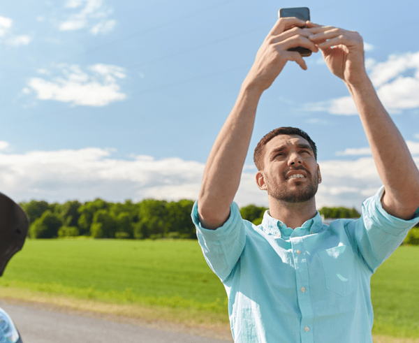 person-tries-to-get-a-cell-signal-while-on-the-road