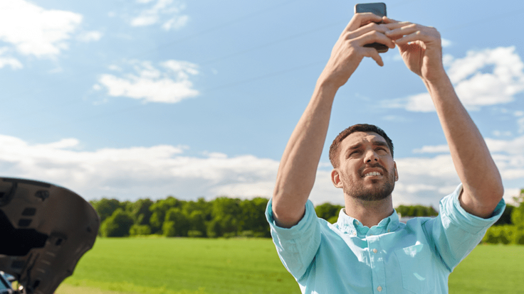 person-tries-to-get-a-cell-signal-while-on-the-road