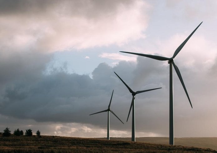 three-wind-turbines-standing-on-a-grassy-landscape